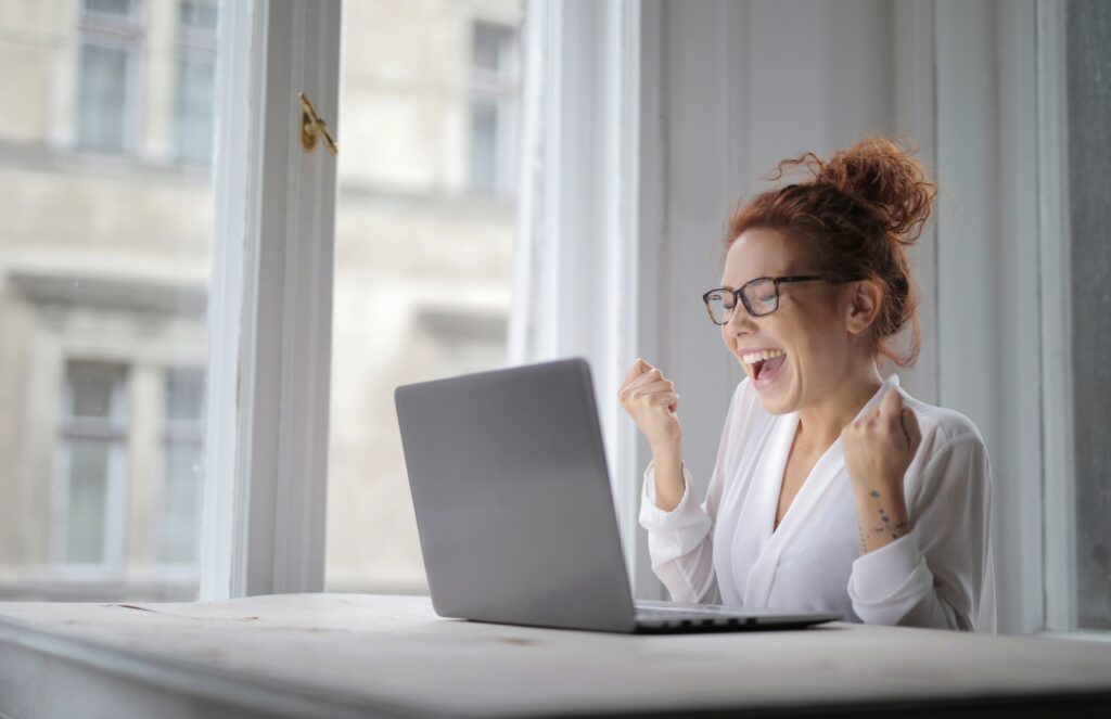 cheerful woman with glasses sitting front laptop table lights house 1
